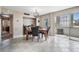 Dining room with tile floors, neutral walls, modern lighting, and sliding glass door to the balcony at 841 4Th N Ave # 57, St Petersburg, FL 33701