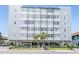 Six-story building with multiple windows and gray siding over parking and main entrance at 841 4Th N Ave # 57, St Petersburg, FL 33701