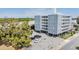 View of Suncoast Towers featuring a light blue exterior, parking and mature trees at 841 4Th N Ave # 57, St Petersburg, FL 33701