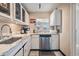 Light and bright kitchen with white cabinets and stainless steel dishwasher at 841 4Th N Ave # 57, St Petersburg, FL 33701