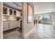 Cozy kitchen with white cabinets, stainless steel appliances, and tile flooring leading to dining area at 841 4Th N Ave # 57, St Petersburg, FL 33701