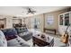 Inviting living room featuring a comfortable gray couch, unique coffee table, and access to a balcony with city views at 841 4Th N Ave # 57, St Petersburg, FL 33701