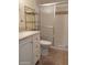 Bathroom featuring a vanity with a sink, toilet, and shower with glass doors at 8567 W Gulf Blvd # 17N, Treasure Island, FL 33706