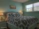 Bright bedroom featuring a queen-sized bed with stylish bedding, a window for natural light, and beach-themed decor at 8567 W Gulf Blvd # 17N, Treasure Island, FL 33706