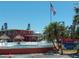Condominium community pool with palm trees and lounge chairs surrounding it at 8567 W Gulf Blvd # 17N, Treasure Island, FL 33706