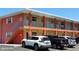 Two-story condo building with a bright, colorful exterior and ample parking at 8567 W Gulf Blvd # 17N, Treasure Island, FL 33706