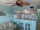 Open-concept kitchen featuring a breakfast bar with stools and a comfortable living area at 8567 W Gulf Blvd # 17N, Treasure Island, FL 33706