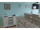 View of the kitchen featuring granite countertops and white cabinets with wicker baskets for storage at 8567 W Gulf Blvd # 17N, Treasure Island, FL 33706