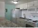 Bright kitchen featuring white cabinets, granite countertops, and modern appliances at 8567 W Gulf Blvd # 17N, Treasure Island, FL 33706
