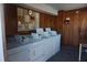 Clean laundry room features modern washing machines, wood paneled walls, and posted notifications at 8567 W Gulf Blvd # 17N, Treasure Island, FL 33706