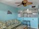 Living room with couches, ceiling fan, and small dining area at 8567 W Gulf Blvd # 17N, Treasure Island, FL 33706