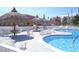 Community pool featuring plenty of seating, umbrellas, and clear water to enjoy at 8567 W Gulf Blvd # 17N, Treasure Island, FL 33706