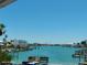 Stunning waterfront view with docks, lush greenery, and a clear blue sky at 8567 W Gulf Blvd # 17N, Treasure Island, FL 33706
