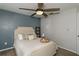 Cozy bedroom featuring a ceiling fan, comfortable bed with stylish pillows, and tasteful decor at 8713 Hampden Dr, Tampa, FL 33626