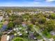 Aerial view of the community, surrounded by lush greenery, showcasing the city skyline in the distance at 9307 N 27Th St, Tampa, FL 33612