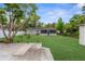 Well-maintained backyard featuring a screened-in porch and lush lawn at 9307 N 27Th St, Tampa, FL 33612