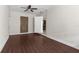 Bedroom featuring dark-toned flooring, crisp white walls, and doors leading to other rooms at 9307 N 27Th St, Tampa, FL 33612