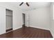Bedroom features closet with sliding doors, light walls and dark floors at 9307 N 27Th St, Tampa, FL 33612