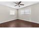 This bedroom features a ceiling fan, two windows, and clean, neutral-colored walls at 9307 N 27Th St, Tampa, FL 33612