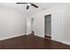 This bedroom has modern wood-look floors, closet, ceiling fan, and freshly painted walls at 9307 N 27Th St, Tampa, FL 33612