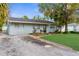 Charming single-story home with a well-manicured lawn and a driveway at 9307 N 27Th St, Tampa, FL 33612