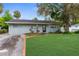 Charming single-story home with a lush green lawn and mature landscaping, offering great curb appeal at 9307 N 27Th St, Tampa, FL 33612