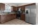Updated kitchen featuring stainless steel appliances, granite countertops, and mosaic tile backsplash at 9307 N 27Th St, Tampa, FL 33612