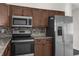 Gourmet kitchen features stainless steel appliances, granite countertops, and designer tile backsplash at 9307 N 27Th St, Tampa, FL 33612