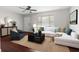 Bright living room with a cozy sectional sofa, modern furnishings, and a ceiling fan at 9307 N 27Th St, Tampa, FL 33612