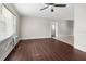 Living room featuring wood-look flooring, a ceiling fan, and natural light at 9307 N 27Th St, Tampa, FL 33612