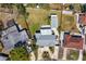 Overhead shot of home with a manicured lawn, long driveway, a detached structure, and fenced yard at 1003 39Th Ne Ave, St Petersburg, FL 33703