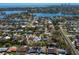 Aerial view of a quiet residential neighborhood with mature trees, waterfront access, and distant skyline at 1003 39Th Ne Ave, St Petersburg, FL 33703