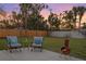 Outdoor patio with chairs and fire pit, perfect for entertaining in a landscaped backyard at 1003 39Th Ne Ave, St Petersburg, FL 33703