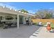 Backyard with covered patio, dining set, grill, lounge seating, and green lawn at 1003 39Th Ne Ave, St Petersburg, FL 33703