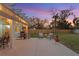 Inviting backyard with a spacious patio, outdoor seating, grill, and lush landscaping under string lights at 1003 39Th Ne Ave, St Petersburg, FL 33703