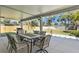Covered backyard patio with dining set, fan, and outdoor grill with a view of the yard at 1003 39Th Ne Ave, St Petersburg, FL 33703