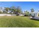 Large backyard with an established lawn area and landscaping near the fence at 1003 39Th Ne Ave, St Petersburg, FL 33703