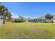 Aerial view of the fenced backyard with patio, outdoor seating, shed, and manicured lawn at 1003 39Th Ne Ave, St Petersburg, FL 33703