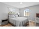 Serene bedroom with neutral tones, wood accents, and two windows at 1003 39Th Ne Ave, St Petersburg, FL 33703