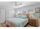 Inviting bedroom with a ceiling fan, natural light, and neutral decor at 1003 39Th Ne Ave, St Petersburg, FL 33703