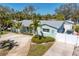 Aerial view of the home exterior highlighting the driveway, gated entrance, and landscaping at 1003 39Th Ne Ave, St Petersburg, FL 33703