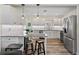 Bright kitchen featuring white cabinets, granite countertops, stainless steel appliances, and hardwood floors at 1003 39Th Ne Ave, St Petersburg, FL 33703