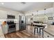 Bright, open kitchen featuring stainless steel appliances, granite countertops, and wood floors at 1003 39Th Ne Ave, St Petersburg, FL 33703