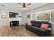 Cozy living room featuring hardwood floors, a comfortable sofa, and a large window at 1003 39Th Ne Ave, St Petersburg, FL 33703