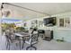 Covered outdoor patio featuring a dining table set, barbecue, fan, and mounted tv at 1003 39Th Ne Ave, St Petersburg, FL 33703