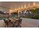 Cozy covered patio features an outdoor dining set, grill, and a fire pit for ultimate outdoor enjoyment at 1003 39Th Ne Ave, St Petersburg, FL 33703