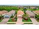 An aerial view of a well-maintained home with lush landscaping and views of a serene pond at 10213 Saint Francis Ter, Palmetto, FL 34221