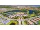 Aerial view of a community with multiple ponds, tennis courts, and a clubhouse with ample parking at 10213 Saint Francis Ter, Palmetto, FL 34221