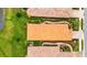 An aerial view of a tiled roof home with pristine landscaping, green lawns, and brick driveways at 10213 Saint Francis Ter, Palmetto, FL 34221