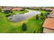 Scenic backyard view featuring lush greenery, a tranquil pond, and meticulous landscaping at 10213 Saint Francis Ter, Palmetto, FL 34221